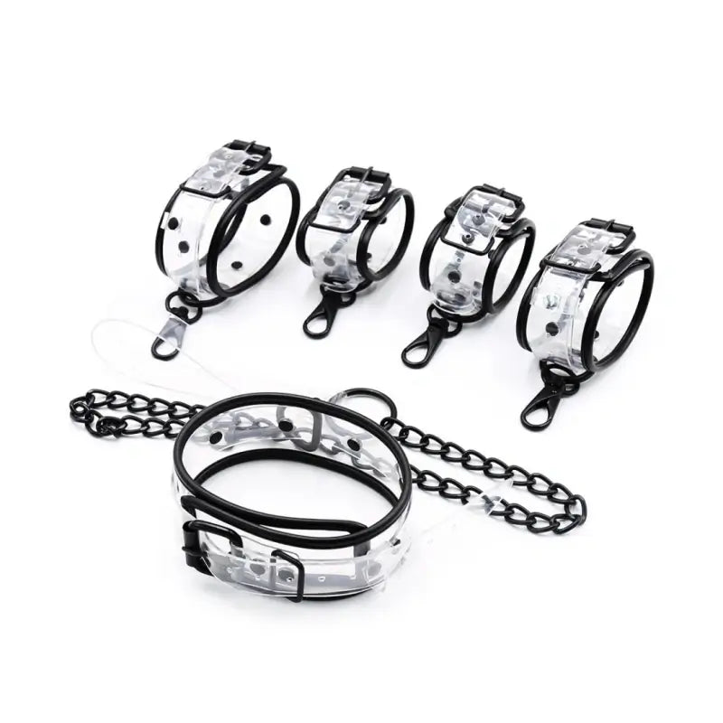 Clear PVC bondage set collar handcuffs and ankle cuffs laid out - Dominitoy 252401233T