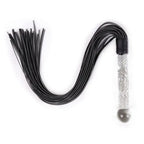 Dominitoy black leather flogger with clear glass-textured handle on white background