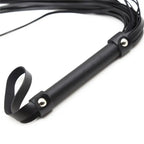 Close-up of Dominitoy black flogger studded handle and leather wrist loop
