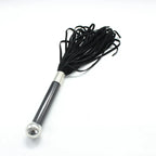 Dominitoy black suede flogger angled view on white background
