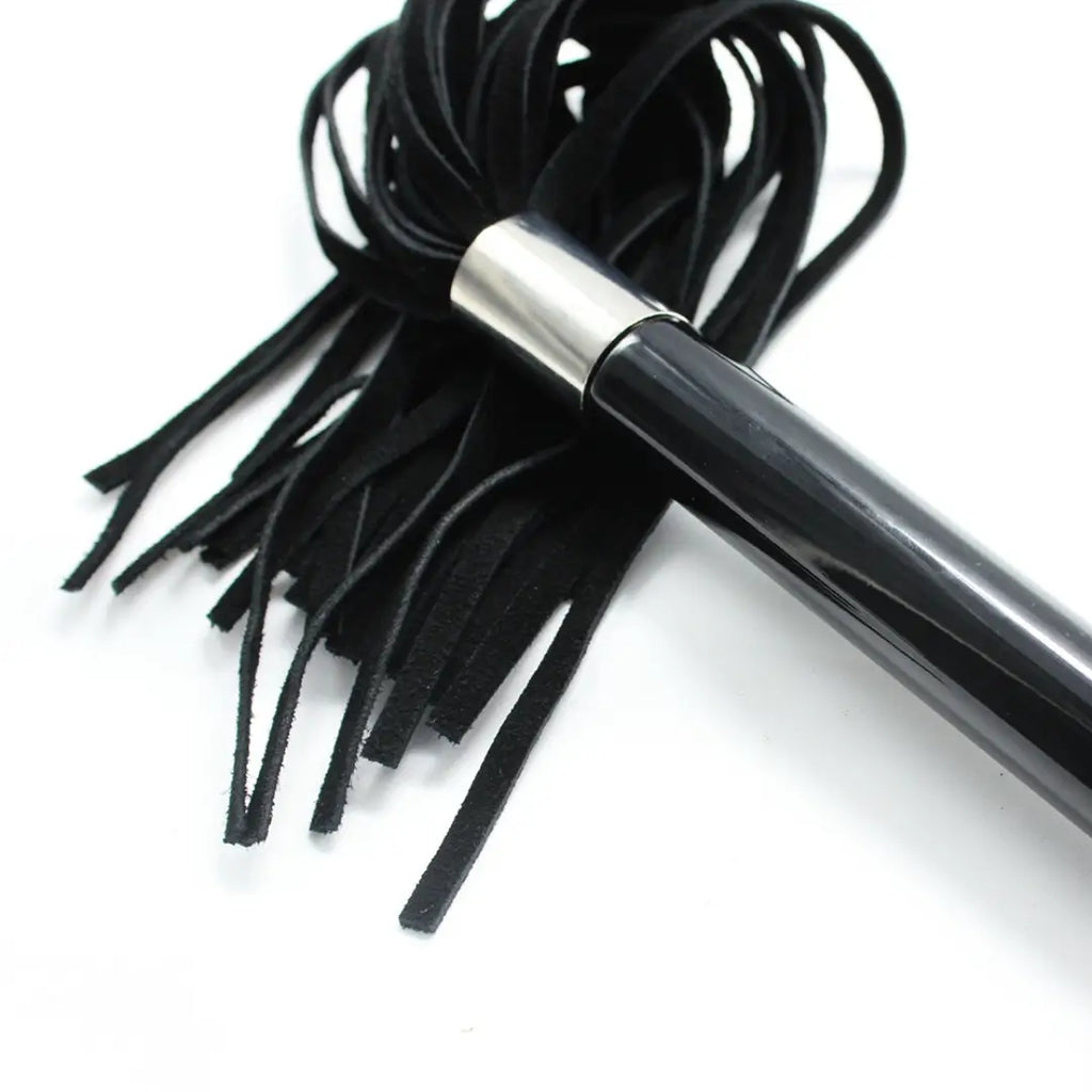 Close-up of Dominitoy suede flogger metal ball handle and suede tails
