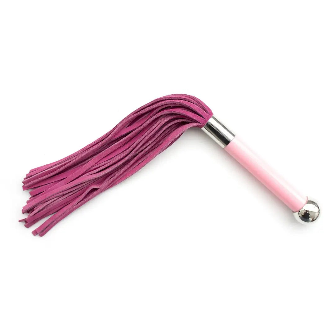 Dominitoy pink double sided suede flogger with metal ball handle on white background

