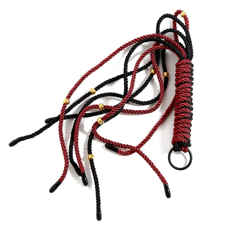 Dominitoy red and black braided flogger crossed flat lay
