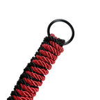 Close-up of Dominitoy rope flogger braided handle with black metal ring