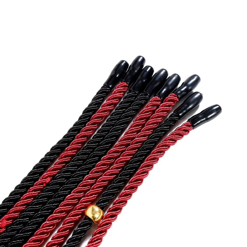 Close-up of Dominitoy braided rope flogger black tips