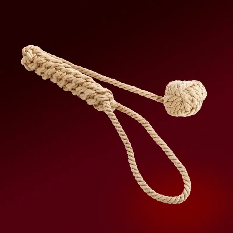 Dominitoy yellow rope ball flogger angled view with braided handle and wrist loop