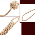 Close-up details of Dominitoy rope ball flogger showing monkey fist knot and handle