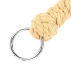 Close-up of Dominitoy rope flogger braided handle and detachable metal ring
