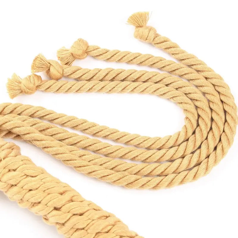  Dominitoy natural yellow rope flogger laid out on white background top view
